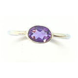Amethyst, cabochon cut lying oval in silver ring