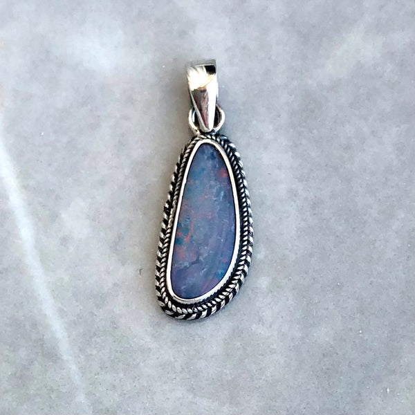 Opal pendant with irregular filigree