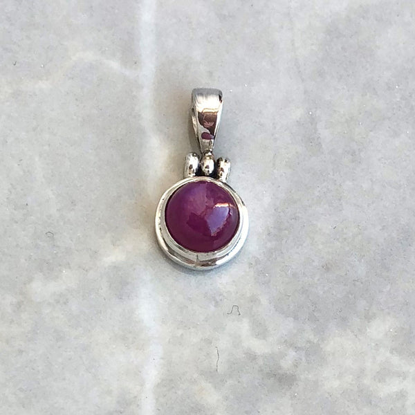 Ruby round pendant with articulated loop